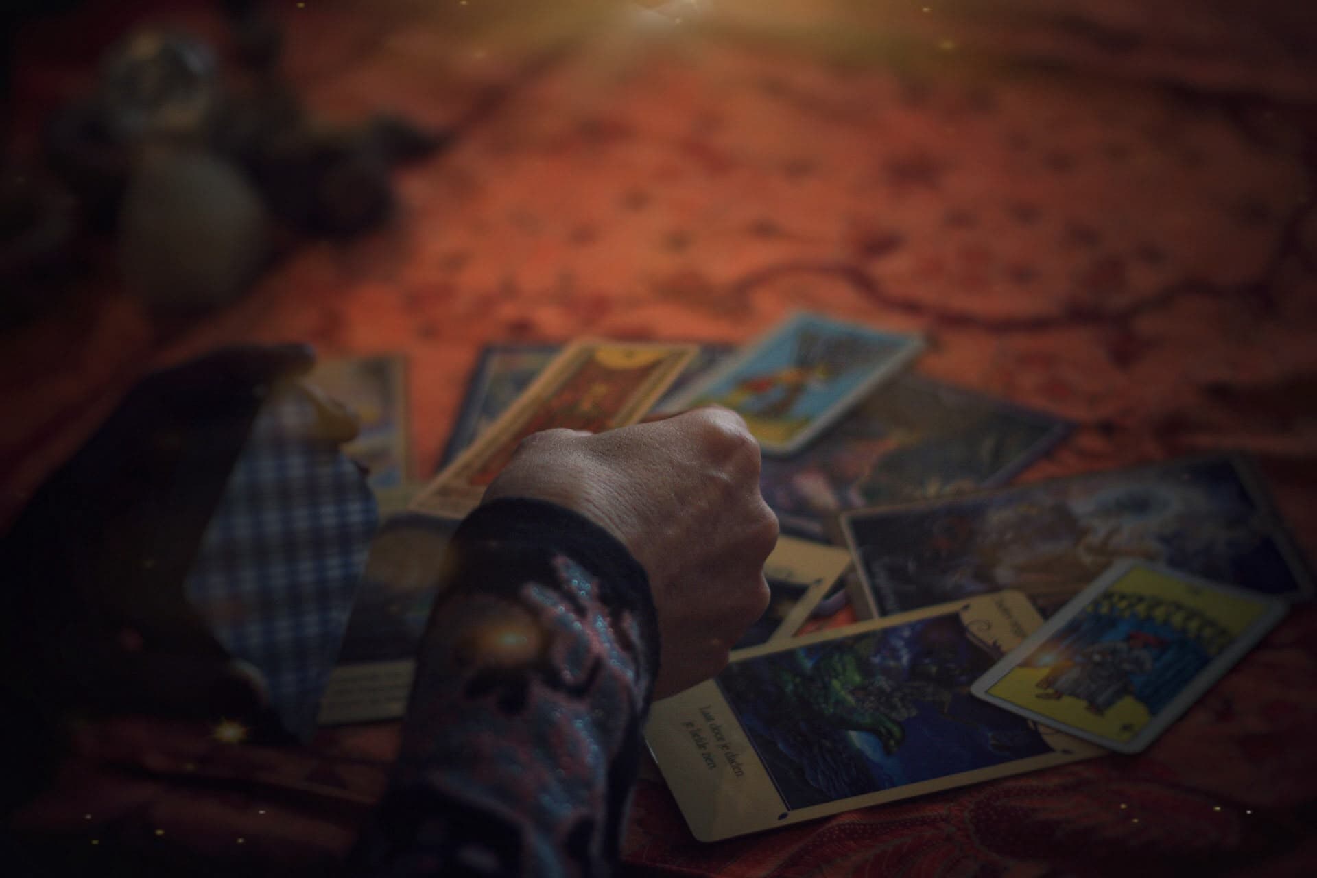 Tarot spread with cards and hands